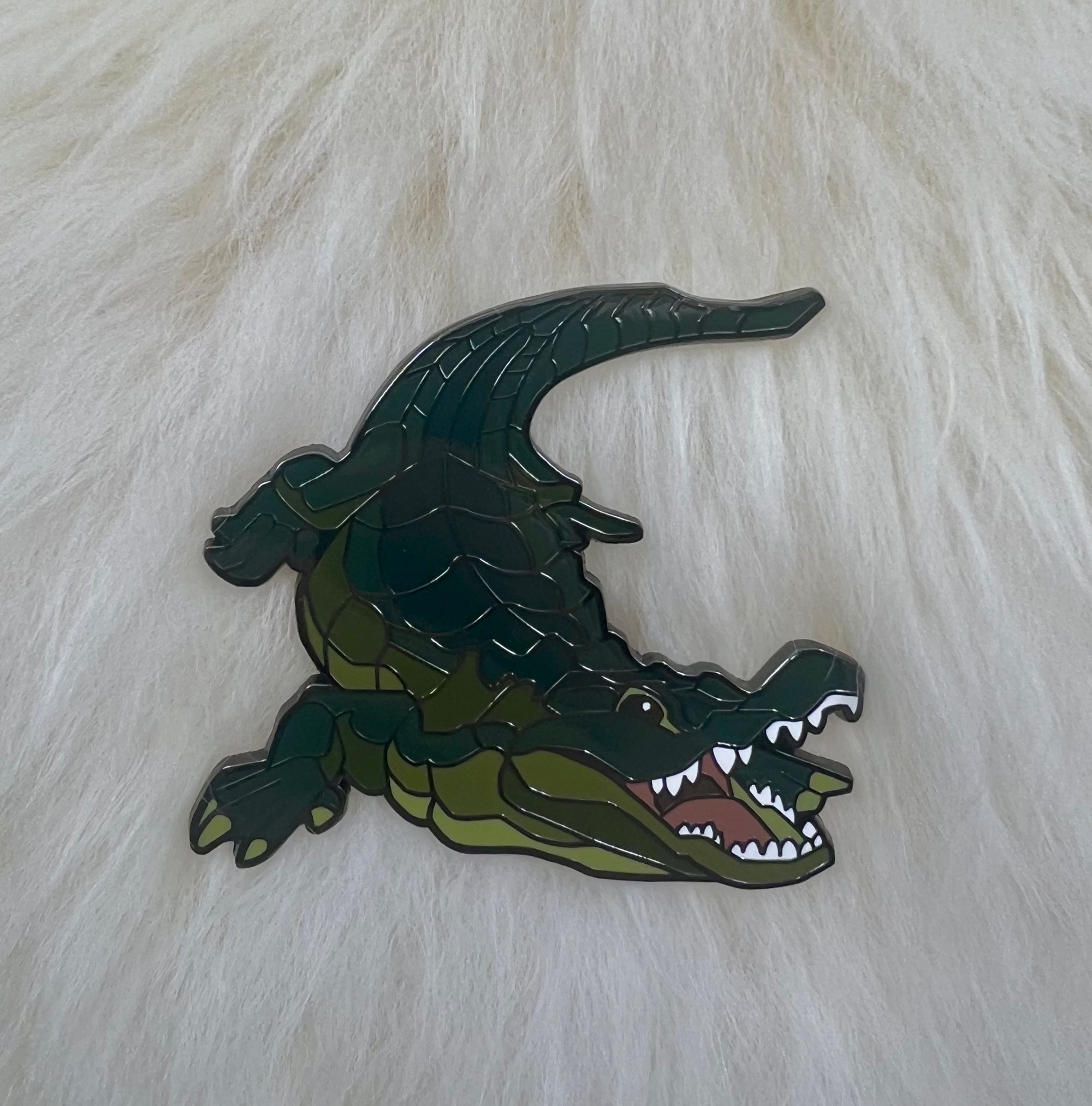 Alligator pin on lambskin background