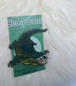 Alligator pin on an artistic backer card