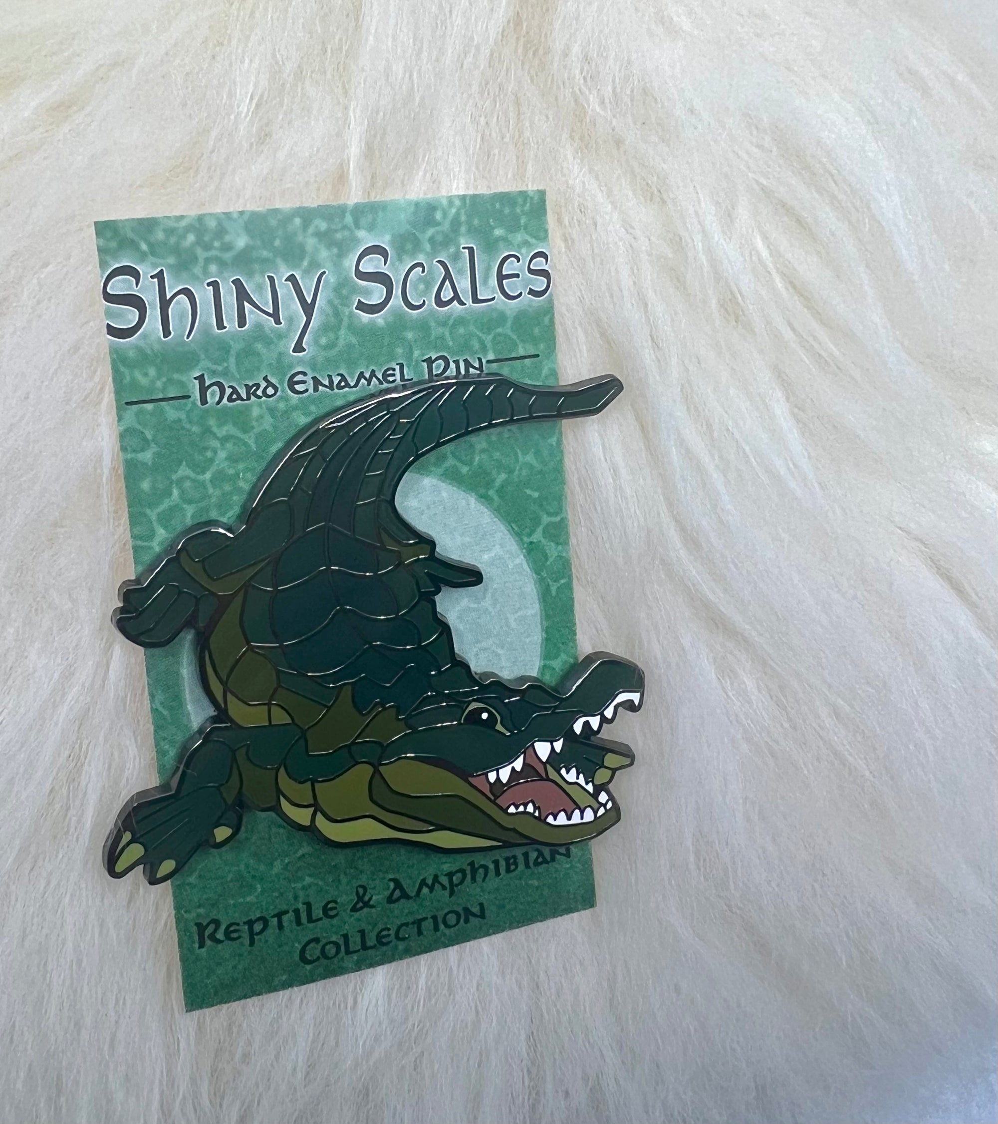 Alligator pin on an artistic backer card