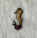 Seahorse pin on lambskin background