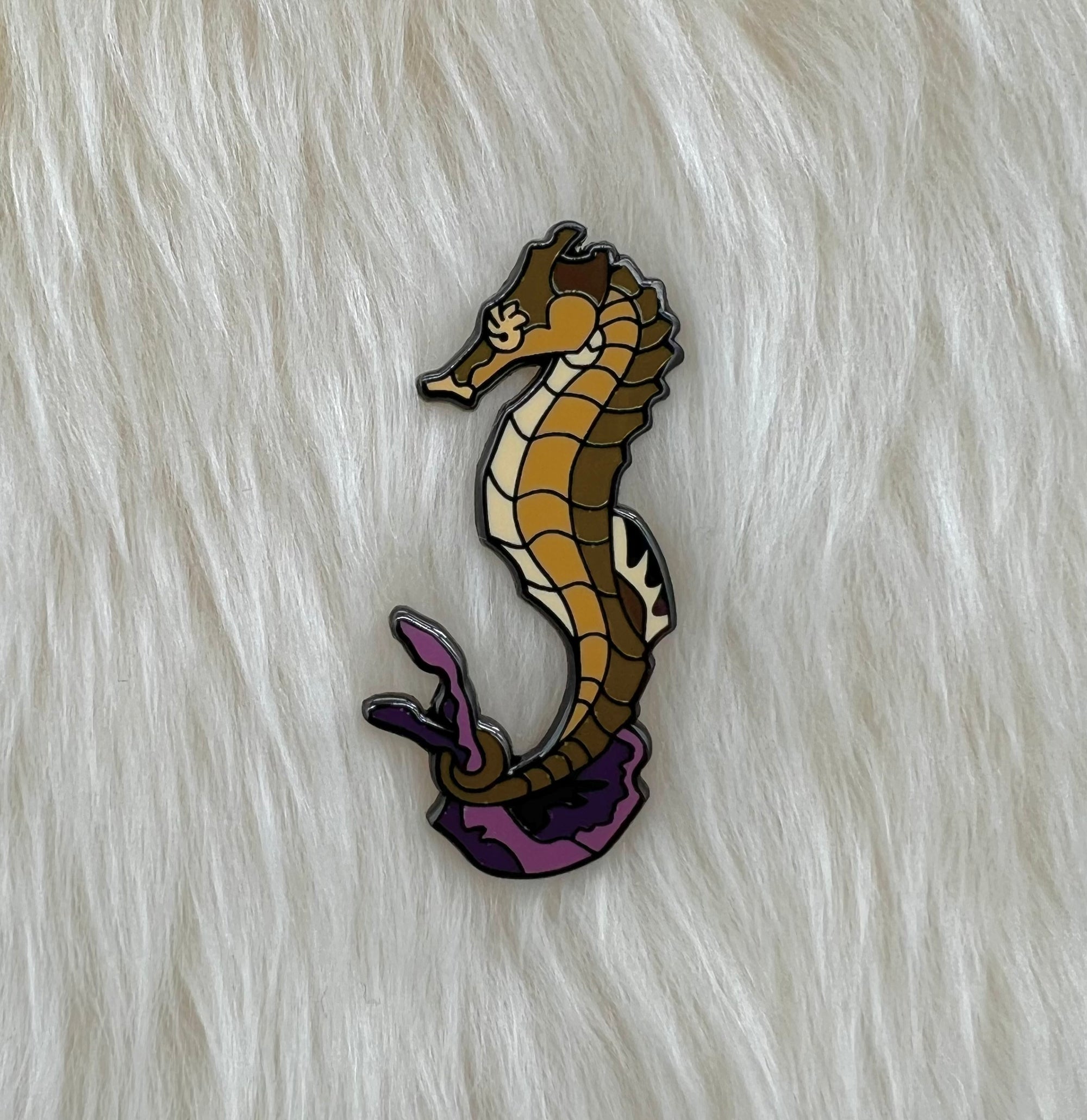 Seahorse pin on lambskin background