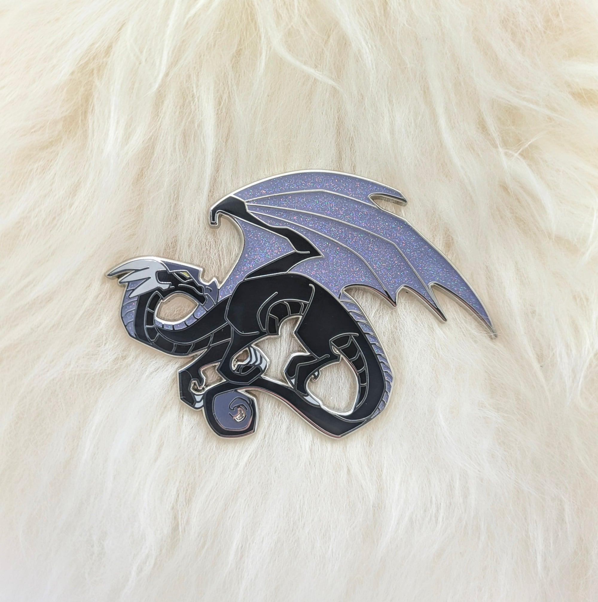 Black dragon pin on white fur