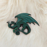Green dragon pin on white fur