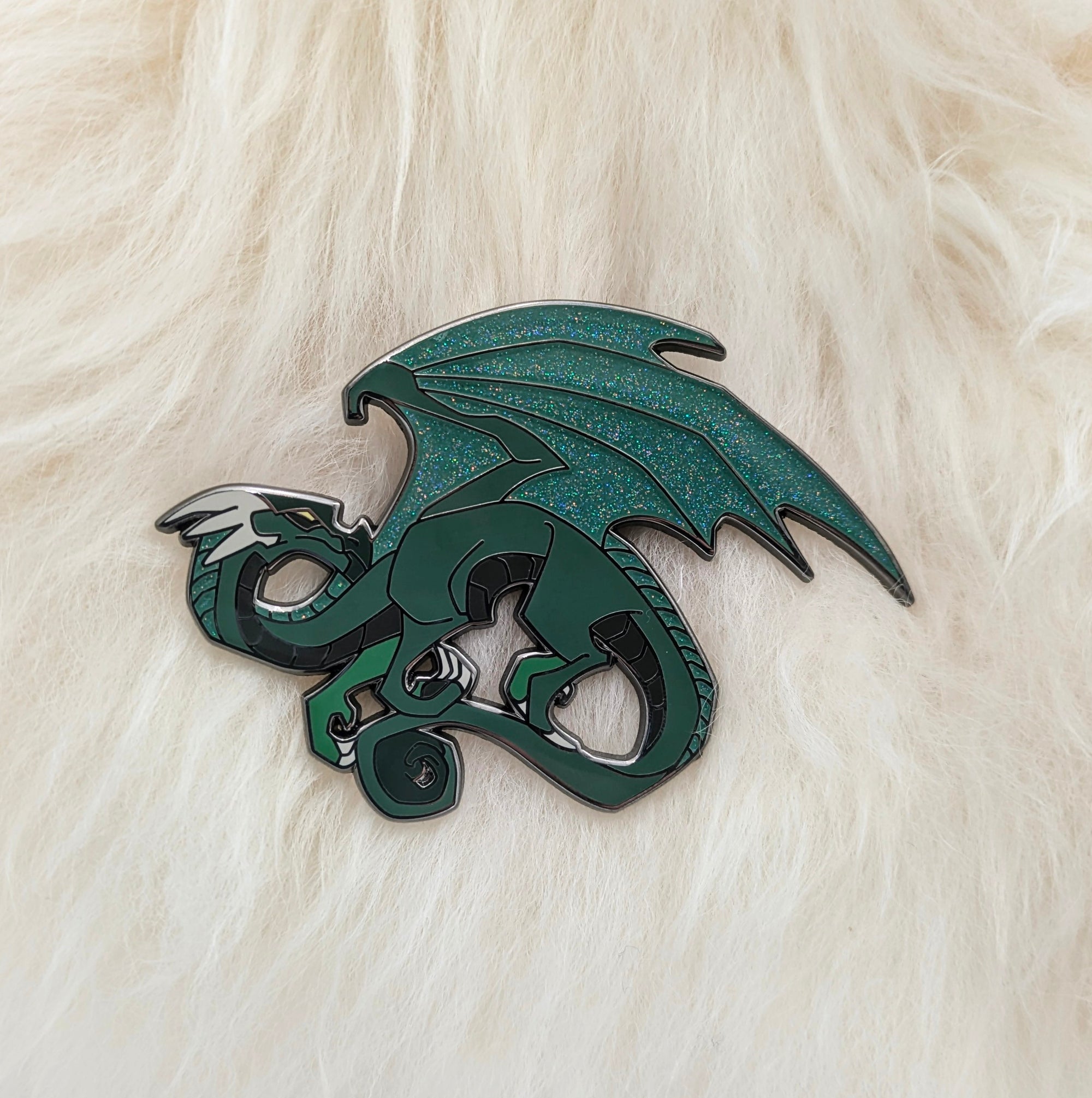 Green dragon pin on white fur