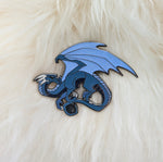 Blue dragon pin on white fur