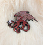 Red dragon pin on white fur