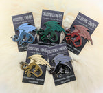 different color dragon pins on decorative backer card