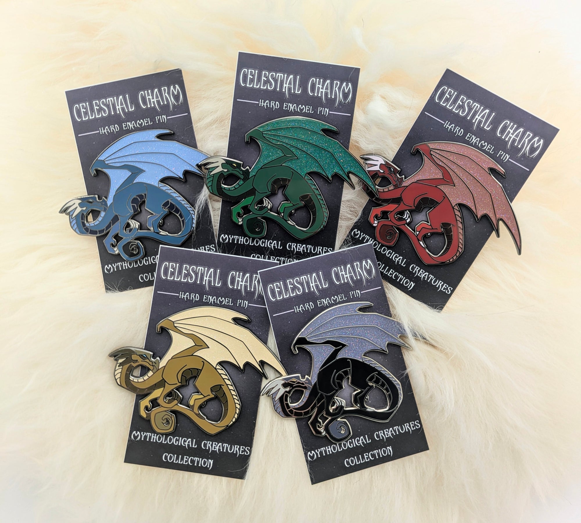 different color dragon pins on decorative backer card
