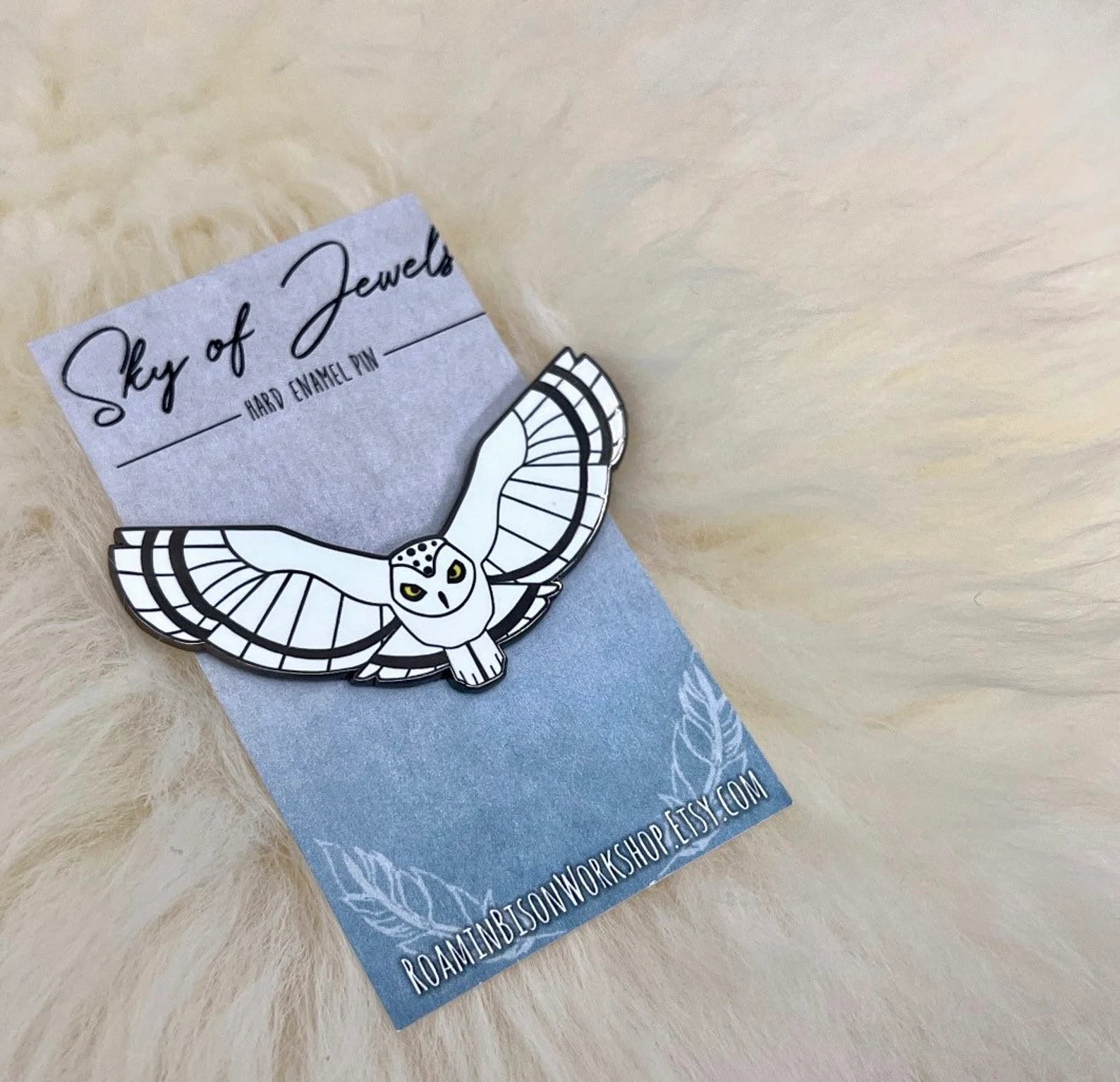 Snowy owl pin on a decorative backer card