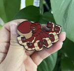 Octopus pin in hand