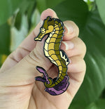 Seahorse pin held in hand